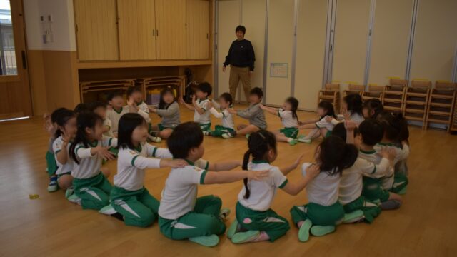✨お別れ会✨3月21日の卒園式を前に、園全体で5歳児さんとの「お別れ会」を行いました。🏃‍♂️交流会では、5歳児さんが各クラスの保育室を訪ねて、それぞれのクラスのお友だちと遊びました。 乳児さんのお部屋では優しく「魚釣り」や「新聞遊び」を教え、幼児さんとは「ジェスチャーゲーム」や「フルーツバスケット」、「リトミック」など、それぞれの年齢に合わせて、目線を小さなお友だちに合わせてやり方を教える姿には、年長児としての自覚と優しさが溢れていました。🌱乳児クラスも幼児クラスも、自分たちの保育室に憧れの5歳児さんが来てくれて大喜び！ 「転がしドッヂ」や「カード合わせ」など、5歳児さんの姿を真似しながら、楽しんでいました。 憧れの5歳児さんがそばにいてくれるだけで、どの子も意欲的に挑戦する姿がとても印象的でした。🎁交流の最後には、ホールに皆が集まり、4歳児さんが手作りした「しおり」をプレゼントしました。 5歳児さんからは、感謝の言葉と歌の披露があり、ホールを出る際は、子どもたち同士で、「また遊ぼうね！」 の声が。いつまでも名残惜しさが残る、優しい時間となりました。 5歳児さんの門出を、職員一同、精一杯の愛を込めてお祝いしたいと思います。#わかば保育園 #お別れ会 #卒園式 #異年齢交流 #5歳児 #心の育ち #大阪市 #生野区 #社会福祉法人 #認可保育園